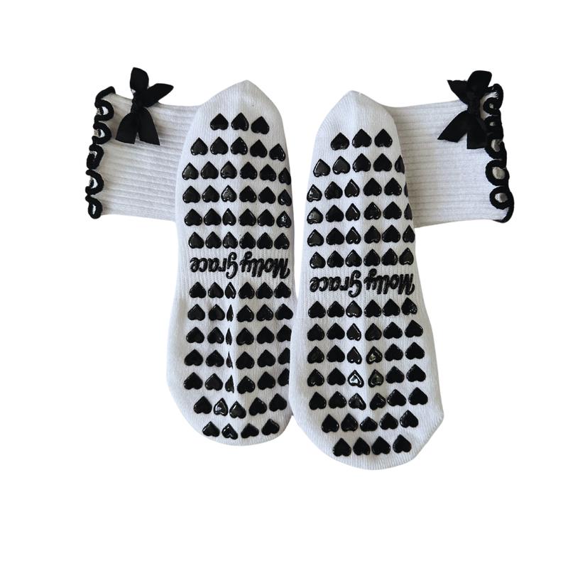 Black and white grip sock with bow and heart grips for pilates, barre, yoga or lagree